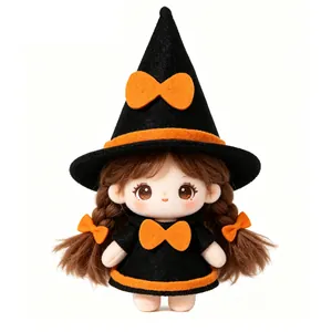 Adorable Halloween plush doll dressed in a witch outfit with a black hat and orange bow.