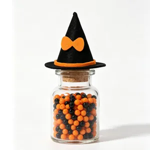 Detailed view of a mini black felt witch hat with an orange bow for Halloween DIY decoration