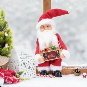 Detailed view of standing Santa Claus figurine holding a Merry Christmas gift box