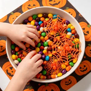 Halloween plastic spider webs for DIY decorations in a candy bowl detail view