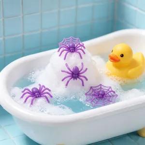 Close-up of purple Halloween plastic spiders and spider webs in a soapy bubble bath