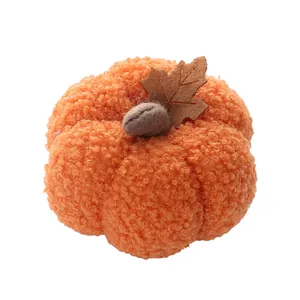 Detail of orange boucle plush pumpkin with brown felt leaf for Halloween decor