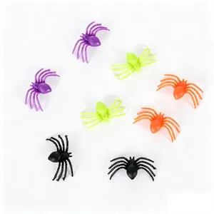 Detail showing assorted colorful mini plastic spiders for Halloween DIY crafts and decor