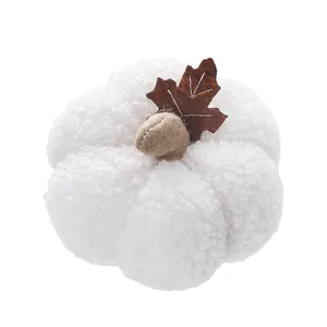 Detailed view of soft white plush pumpkin decoration with brown felt leaf for autumn