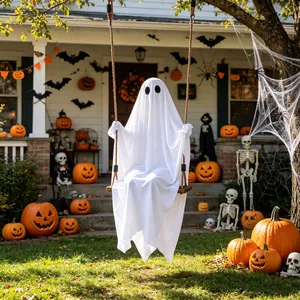 Detailed view of a cute white ghost decoration on a swing in a decorated Halloween yard