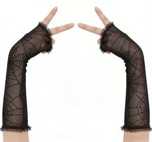 Detailed close-up of spiderweb pattern and elegant lace ruffle on black fingerless gloves
