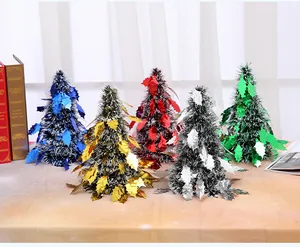 Detailed view of mini tinsel tabletop Christmas trees in five shiny metallic colors