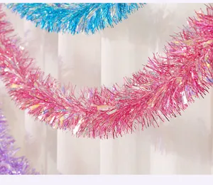 Detail macro shot of sparkling pink and blue Christmas tinsel garlands for festive room decoration