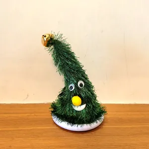 Close-up of animated Christmas tree toy with bell and cute face detail