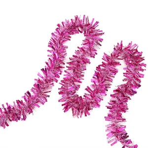 Vibrant magenta sparkling Christmas tinsel garland for festive holiday party home decoration