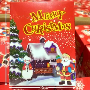 Close-up detail of 10x8cm red Christmas gift box with Santa and snowman illustrations