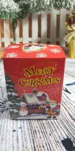 Detail of red Christmas gift box with Santa Claus and snowman patterns