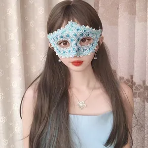 Elegant light blue lace masquerade mask with blue sequins on a female model for party