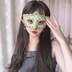 Close-up of elegant green lace masquerade mask worn by a woman for party costumes.