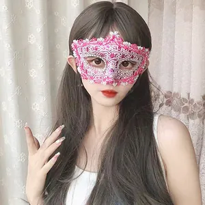 Close-up of an elegant pink and white lace masquerade mask worn by a beautiful model