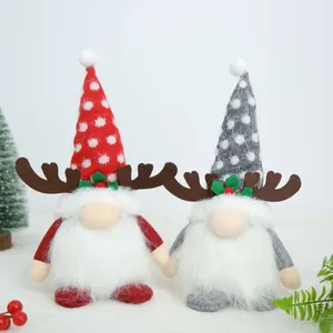 Detailed view of two cute Christmas gnomes with reindeer antlers and soft white beards