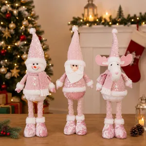 Macro view of pink sequined Christmas doll set featuring Santa, Snowman and Reindeer