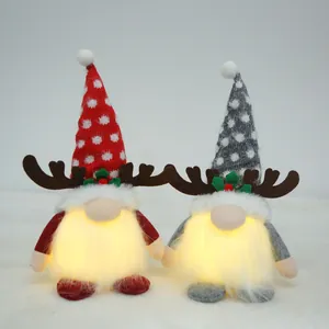 Two adorable Christmas gnomes with glowing beards and reindeer antlers for holiday decor