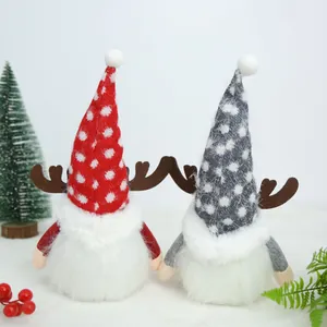 Close-up of Christmas gnome plush dolls with reindeer antlers and dotted hats