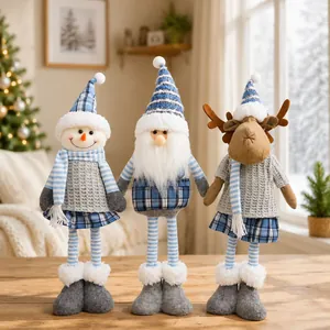 Group of three Christmas plush figurines with blue plaid hats and telescopic legs on wooden table