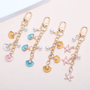 Lot de 4 porte-clés thème marin avec coquillages, étoiles de mer et perles nacrées