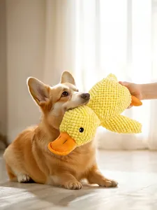 Squeaky plush yellow duck dog toy shown being used by a Corgi in a home setting