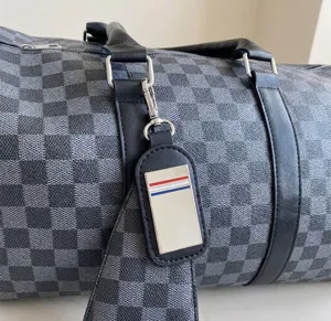 Makro-Detail des Gepäckanhängers der Reisetasche mit Schachbrettmuster und Metallplatte
