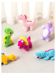 Group of colorful dinosaur squeaky plush dog toys on a neutral carpet background