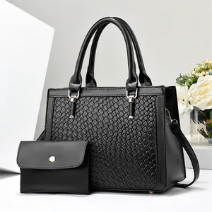Detail view of stylish black woven texture handbag and matching small purse set for women
