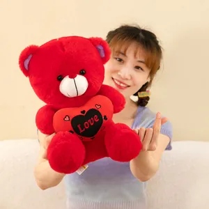Red plush teddy bear holding a heart with Love embroidery, perfect for gift giving