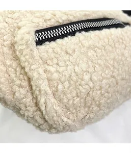 Close-up detail of beige fuzzy plush crossbody bag showing soft teddy fleece texture
