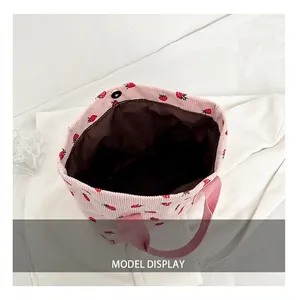 Detailed view of the brown inner lining of the pink strawberry print corduroy tote bag