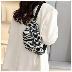 Detail view showing a soft plush zebra print chest bag worn over a white blazer