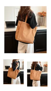 Versatile brown canvas tote bag for women shown in a lifestyle office setting
