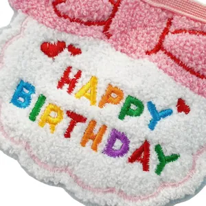 Soft plush pet birthday bib with colorful Happy Birthday embroidery and red hearts.