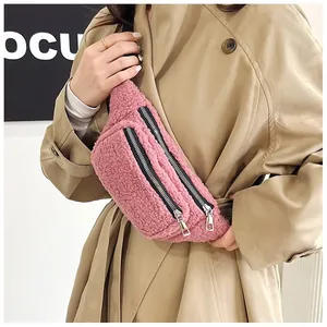 Close-up of stylish pink sherpa fleece belt bag with functional double zipper detail worn over a coat