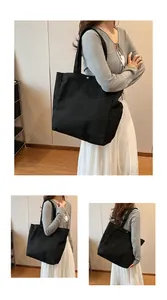 Three-view display of a black canvas tote bag worn by a model in an indoor setting