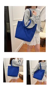 Lifestyle detail of a blue canvas tote bag showing different carrying angles on a model