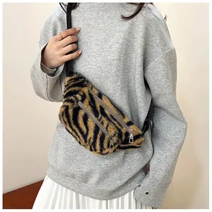 Detail view of plush tiger print chest bag styled with a gray sweatshirt for daily use