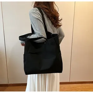 High-quality lifestyle view of a large black canvas tote bag for women shoulder wear
