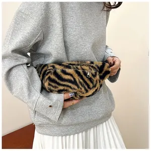 Detail shot of a cute fuzzy tiger pattern chest bag for women in a casual outfit