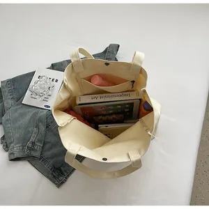Detailed close-up of open canvas tote bag interior showing spacious capacity and pockets