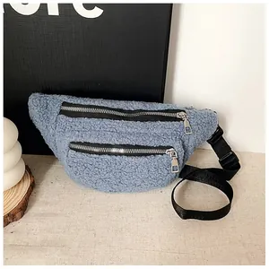 Close-up of a blue teddy fleece chest bag with double black zippers and adjustable strap.