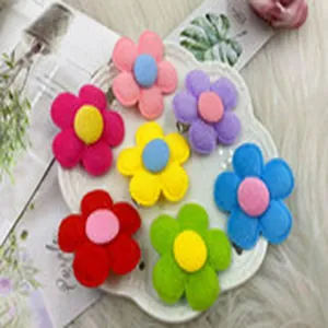 Close-up of colorful handmade felt flower accessories for DIY hair clips and headbands