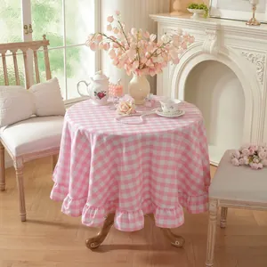 Detail of pink and white checkered round tablecloth with elegant ruffled edge design