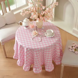 Round pink and white checkered tablecloth with elegant ruffled edge detail