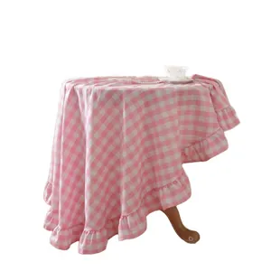 Elegant pink and white checkered round tablecloth with stylish ruffled edge detail