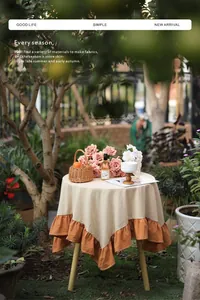 Detail view of modern ruffled hem tablecloth in an outdoor garden setting