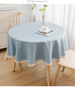 Detailansicht einer hellblauen runden Tischdecke mit elegantem weißen Spitzenbesatz