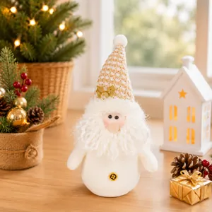 Cute plush Christmas snowman ornament with a gold knitted hat in a warm festive home setting